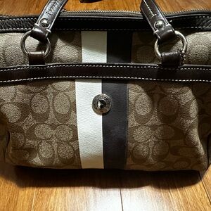 Brown Slightly used coach handbag inside is a gold fabric